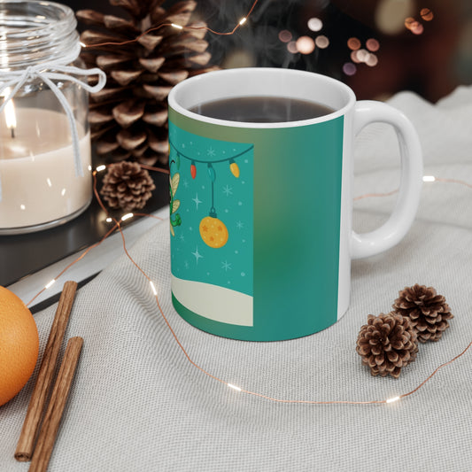 Teal mug with festive design on a table with candles, oranges, and pine cones. Echo