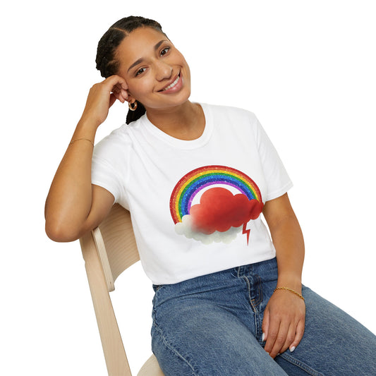 Person wearing a white t-shirt with a rainbow and Buster cloud design, sitting on a chair.