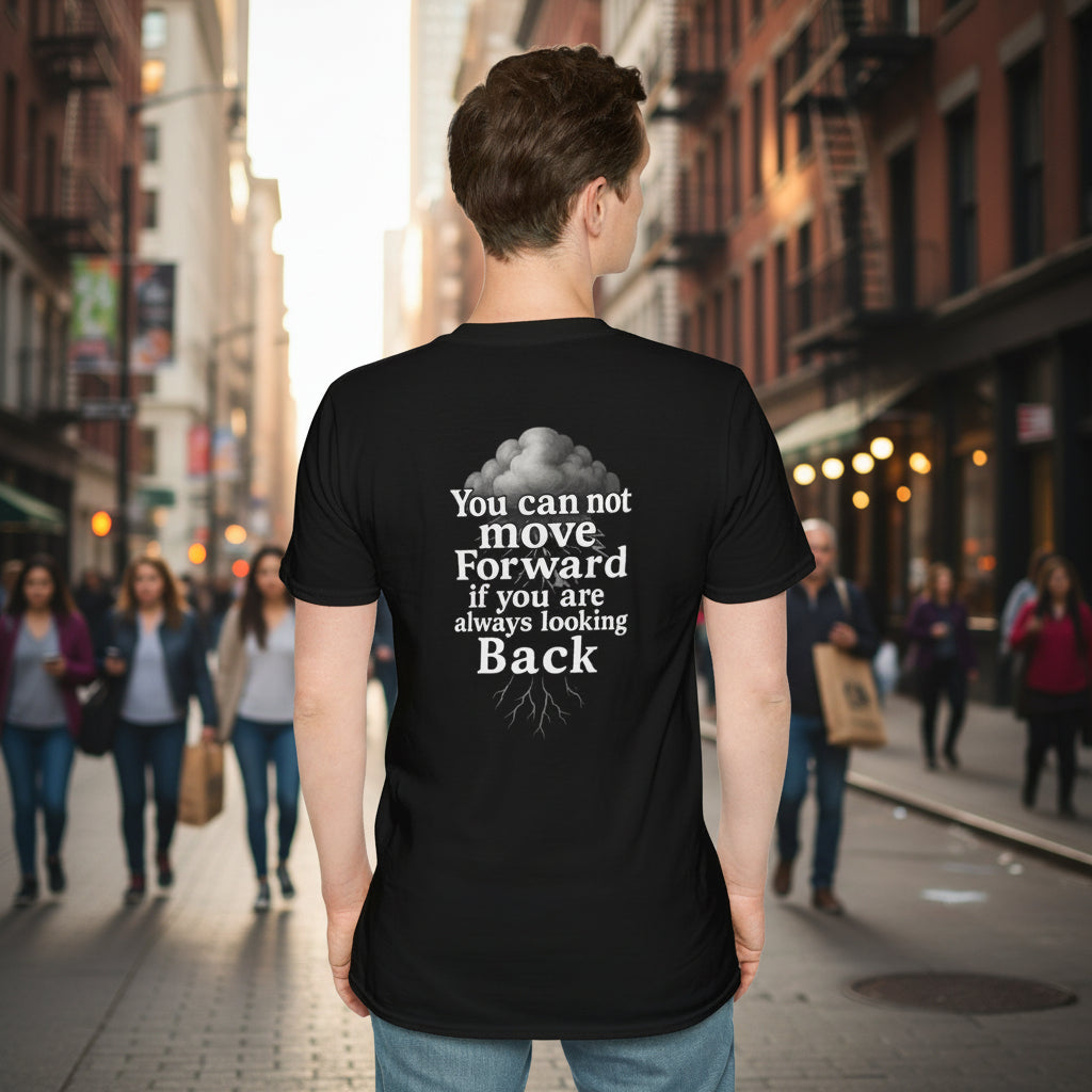 Person wearing a black t-shirt with a motivational quote by storm mosquitos apparel on the back, standing against a street background.