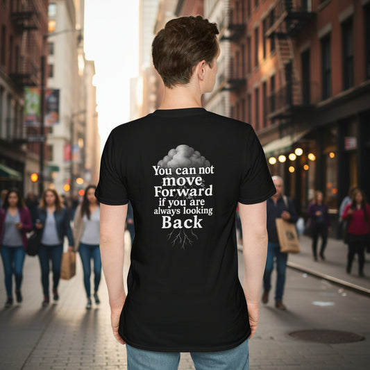 Person wearing a black t-shirt with a motivational quote by storm mosquitos apparel on the back, standing against a street background.