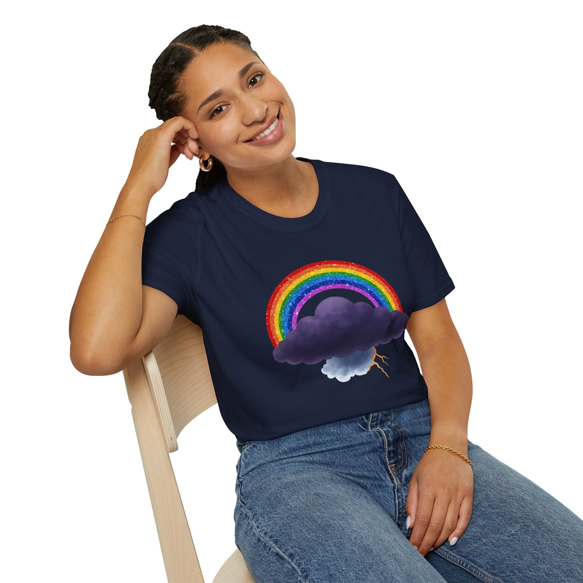 Person wearing a navy blue t-shirt with a colorful rainbow and Tempest cloud design, sitting on a white background.
